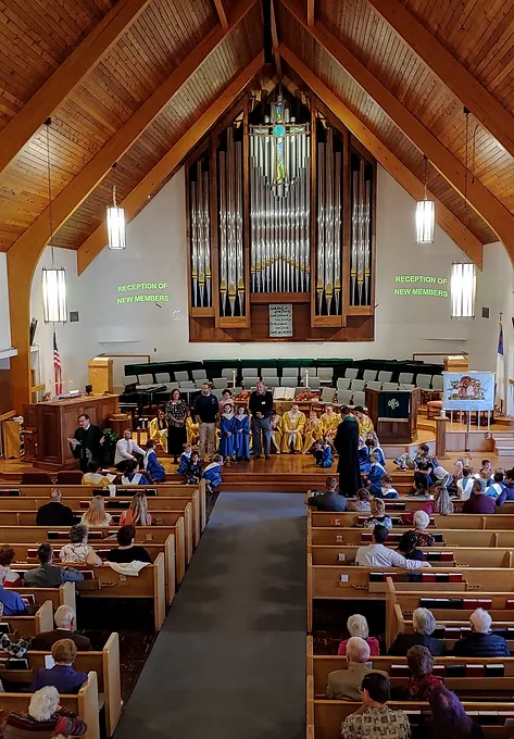 Worshippers gather in the sanctuary of the First Congregational Church UCC Greeley.