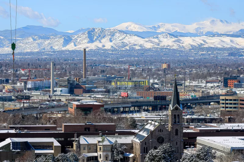 image of buildings in the foreground with mountains in the background