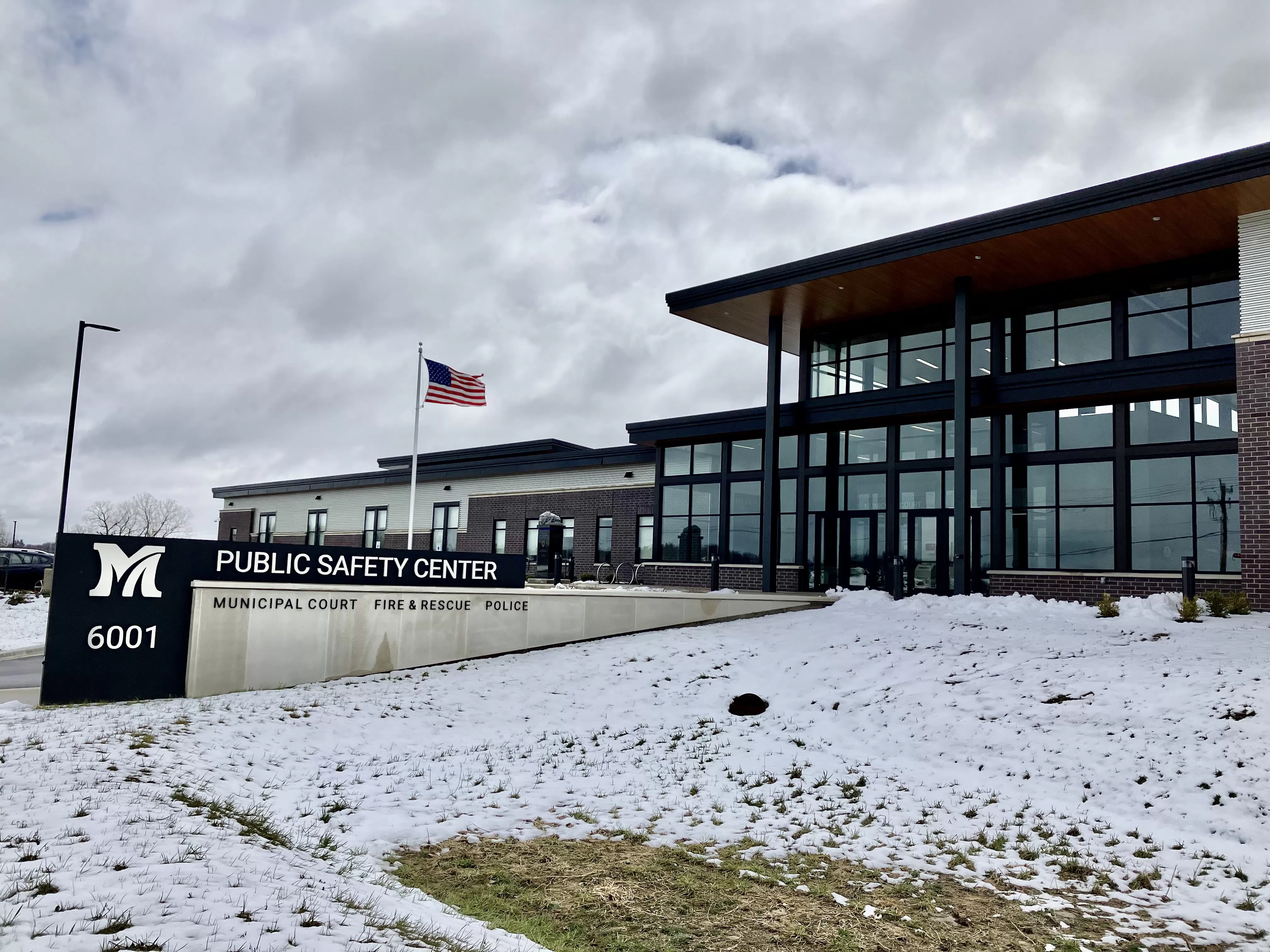 Image of building with big glass windows and sign saying Public Safety Center