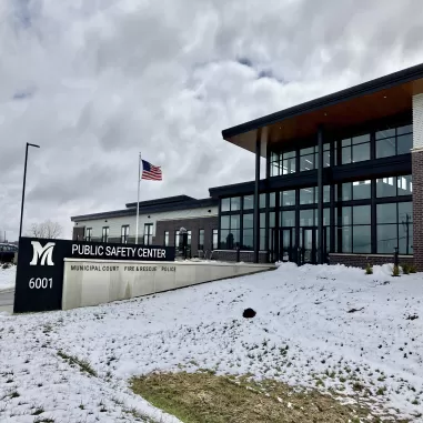 Image of building with big glass windows and sign saying Public Safety Center